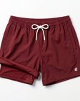 Burgundy sustainable swim shorts with a white drawstring on a white background