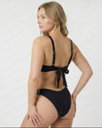 Woman wearing a sustainable black bikini with a white background