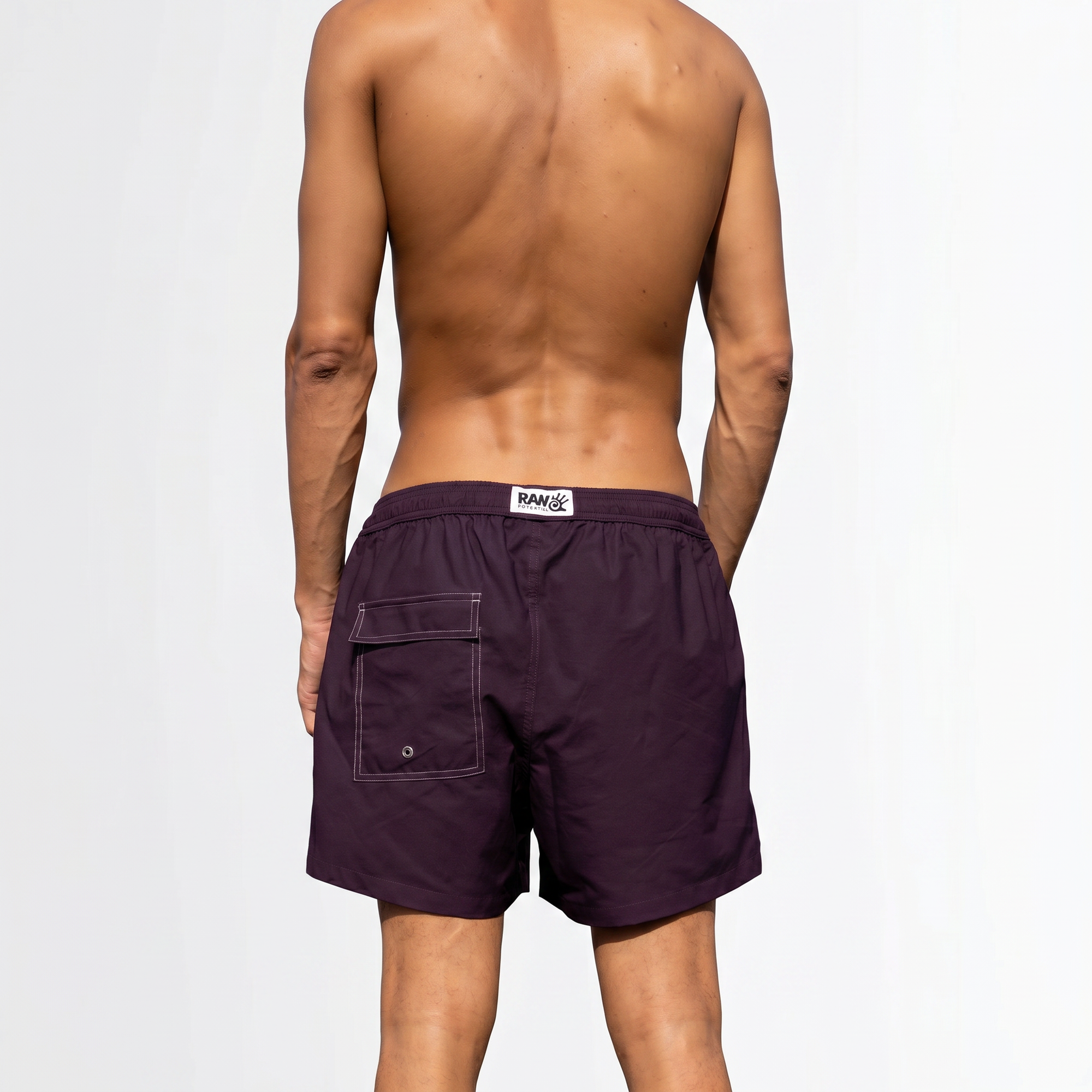 Person wearing purple swim shorts on a white background