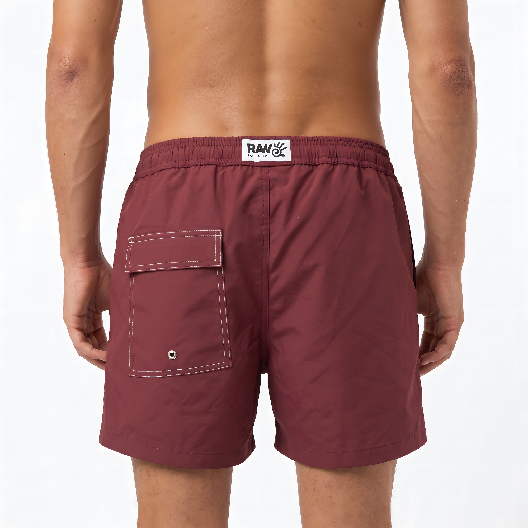 Burgundy swim shorts with a visible brand logo in the centre of the back of the waistband. A back pocket is visible, designed with subtle white stitching for a luxury feeling. The image is shot on a white background.